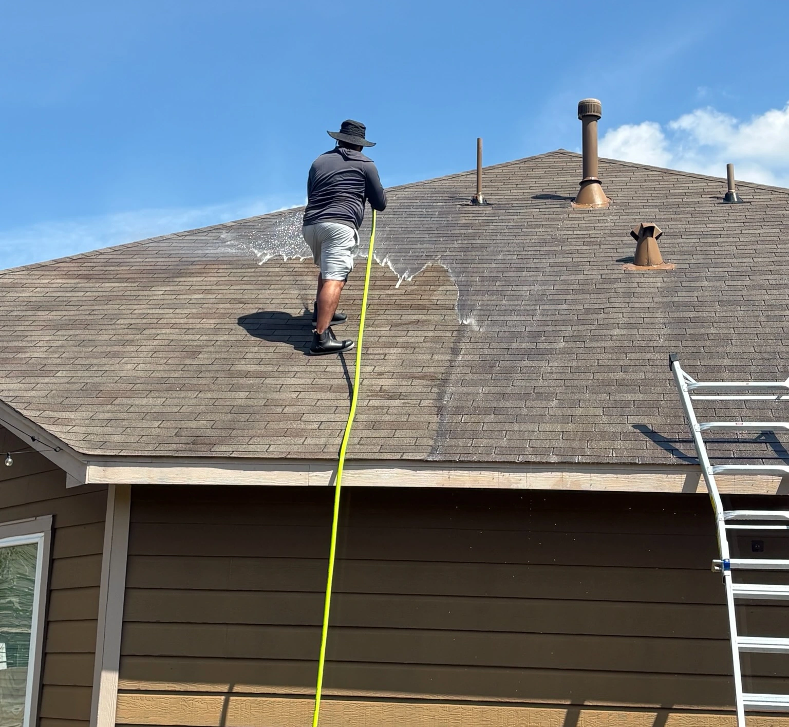 Space City washing a residential roof